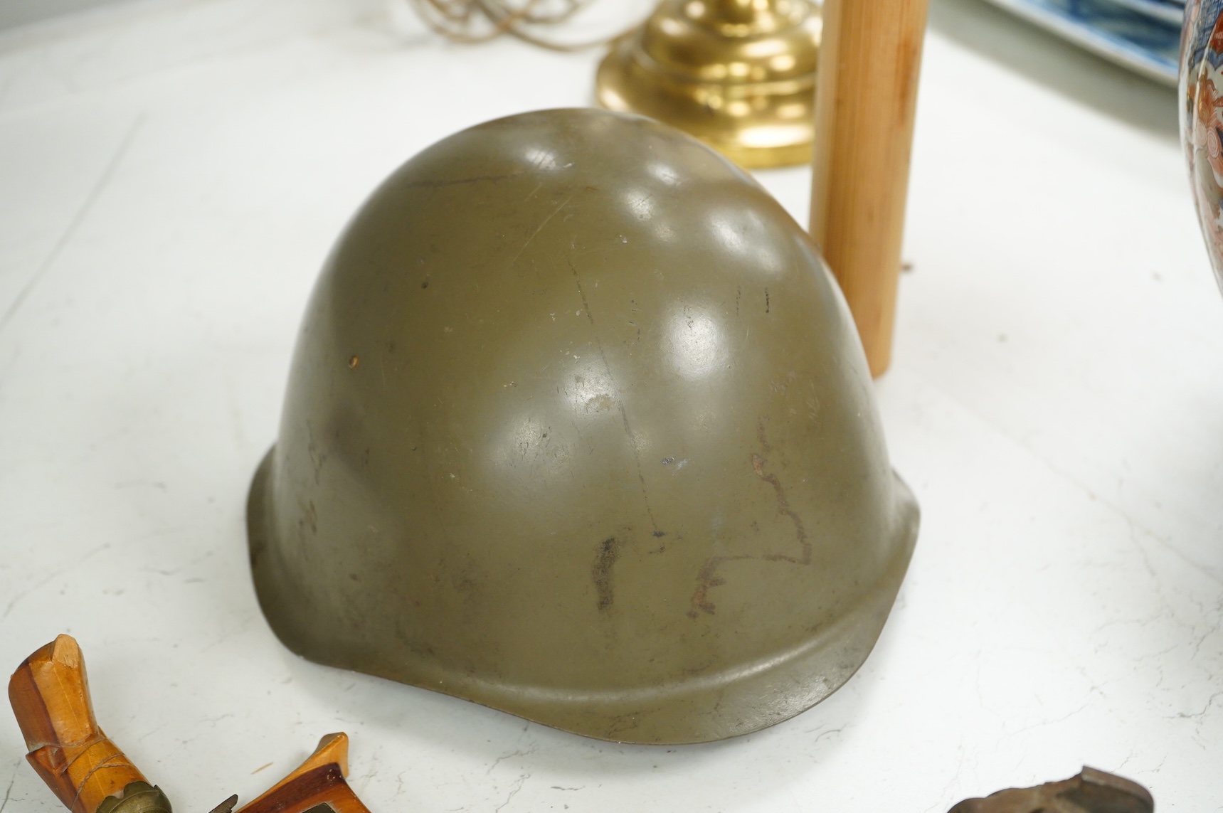 A Czech Vz53 tin helmet with liner, a Kris with applied presentation plaque engraved with ‘Presented by 'C' Battery’ and an inert British Mills hand grenade